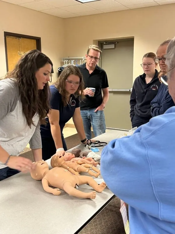 Hands-on pediatric skills practice during a live training session.