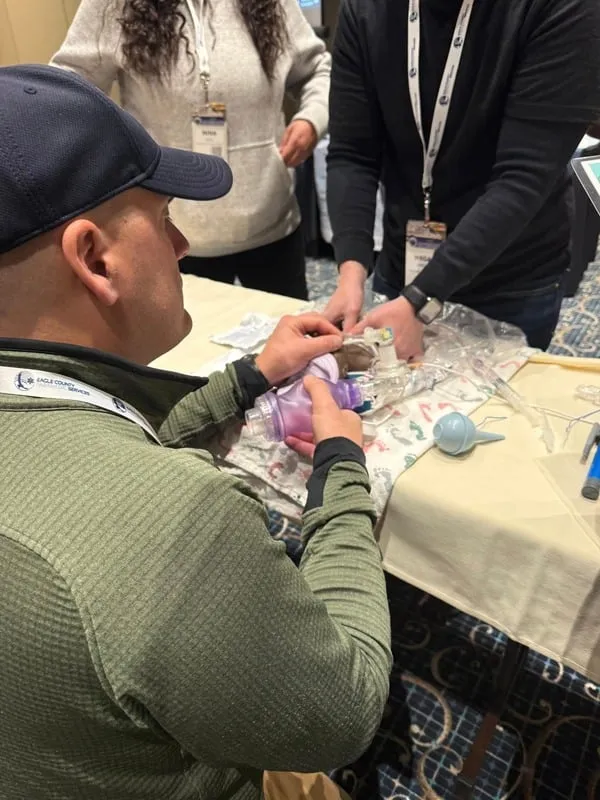 Learners working through a neonatal resuscitation skills check-off.